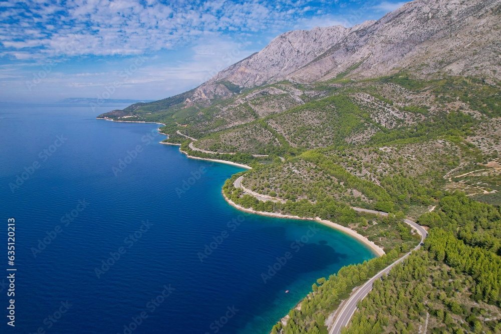 AERIAL: Winding road in breathtaking hilly landscape on coast of Adriatic Sea