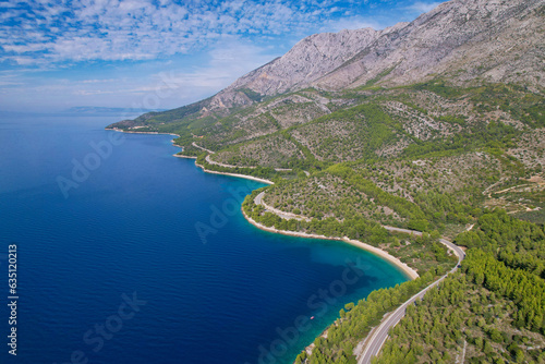 AERIAL: Winding road in breathtaking hilly landscape on coast of Adriatic Sea