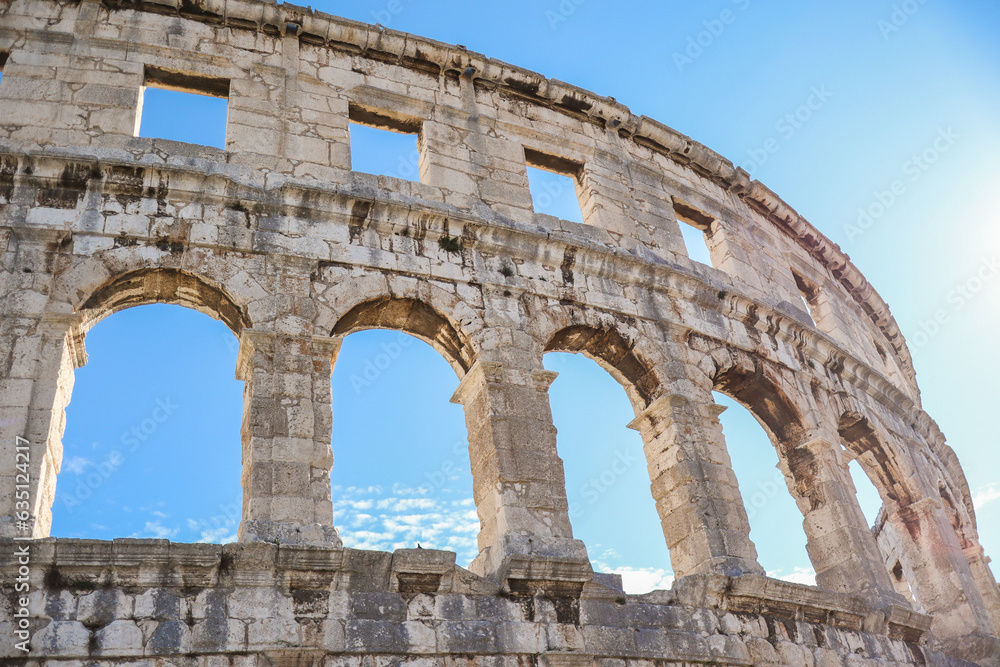 Roman Amphitheater with Arch Window in Croatia. Pula Arena Landmark with Blue Sky. European Monument Outside.