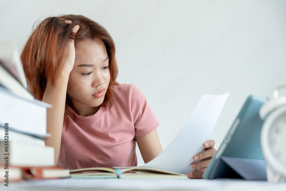Asian student woman have anxiety because of exams, female prepare for test and learning lessons in the library. stress, despair, haste, misunderstanding reading, discouraged, expectation, knowledge Asian student woman have anxiety because of exams, female prepare for test and learning lessons in the library. stress, despair, haste, misunderstanding reading, discouraged, expectation, knowledge