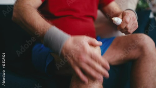Man applying cream ointment on his knee, treatment for arthritis pain, injury