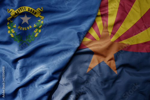big waving colorful national flag of arizona state and flag of nevada state .