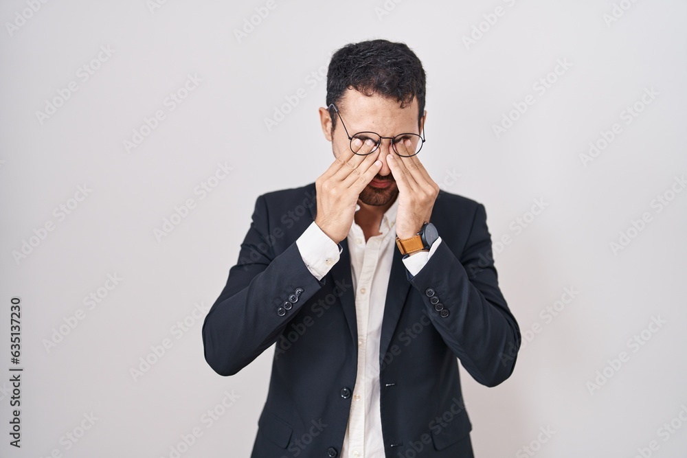 Handsome business hispanic man standing over white background rubbing eyes for fatigue and headache, sleepy and tired expression. vision problem