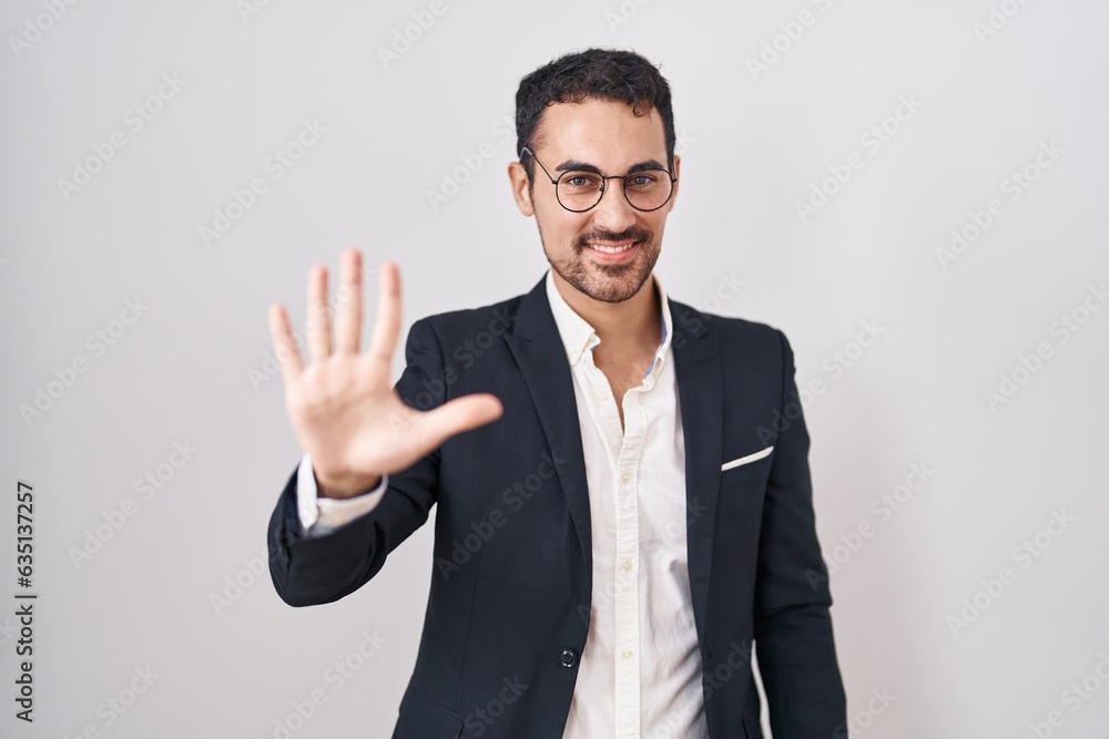 Handsome business hispanic man standing over white background showing and pointing up with fingers number five while smiling confident and happy. Handsome business hispanic man standing over white background showing and pointing up with fingers number five while smiling confident and happy.