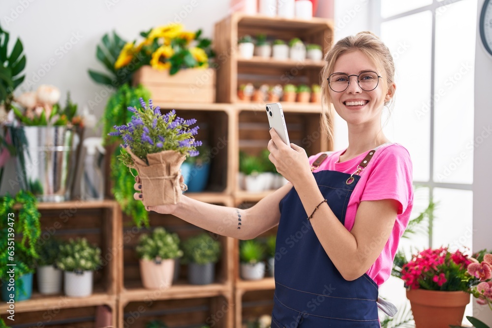 Young blonde woman florist make photo to lavender plant by smartphone at flower shop