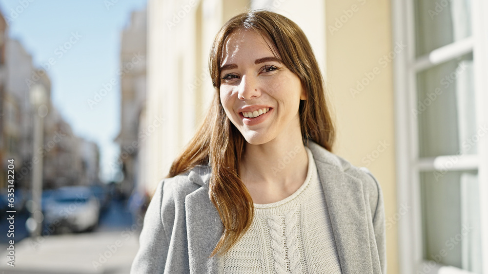 Fototapeta premium Young hispanic woman smiling confident at street