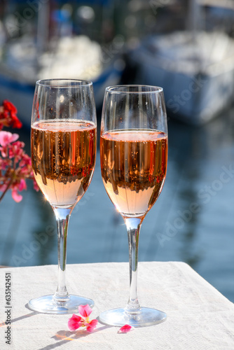Summer party  drinking of French brut rose champagne sparkling wine in glasses in yacht harbour of Port Grimaud near Saint-Tropez  French Riviera vacation  France