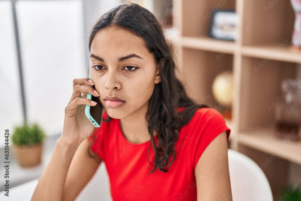 Young african american woman talking on the smartphone with serious expression at home Young african american woman talking on the smartphone with serious expression at home