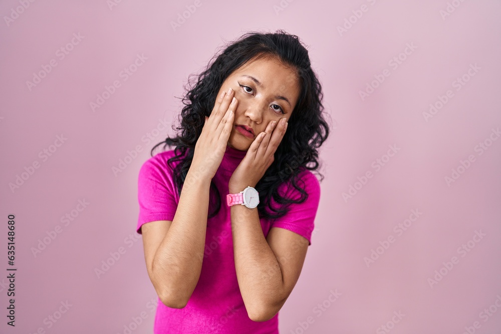 Young asian woman standing over pink background rubbing eyes for fatigue and headache, sleepy and tired expression. vision problem Young asian woman standing over pink background rubbing eyes for fatigue and headache, sleepy and tired expression. vision problem