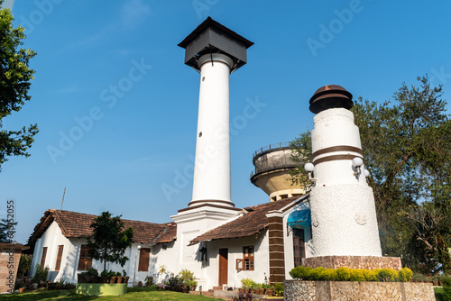 Mangalore, India - January 18 2023: The old lighthouse built by Hyder Ali surrounded by modern high rise skyscrapers in the city of Mangaluru. photo