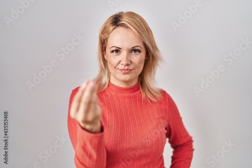 Wallpaper Mural Blonde woman standing over isolated background doing italian gesture with hand and fingers confident expression Torontodigital.ca