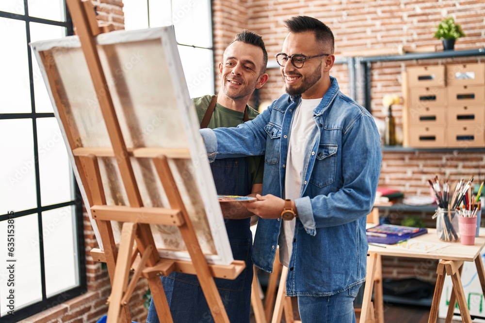 Two men artists smiling confident drawing at art studio