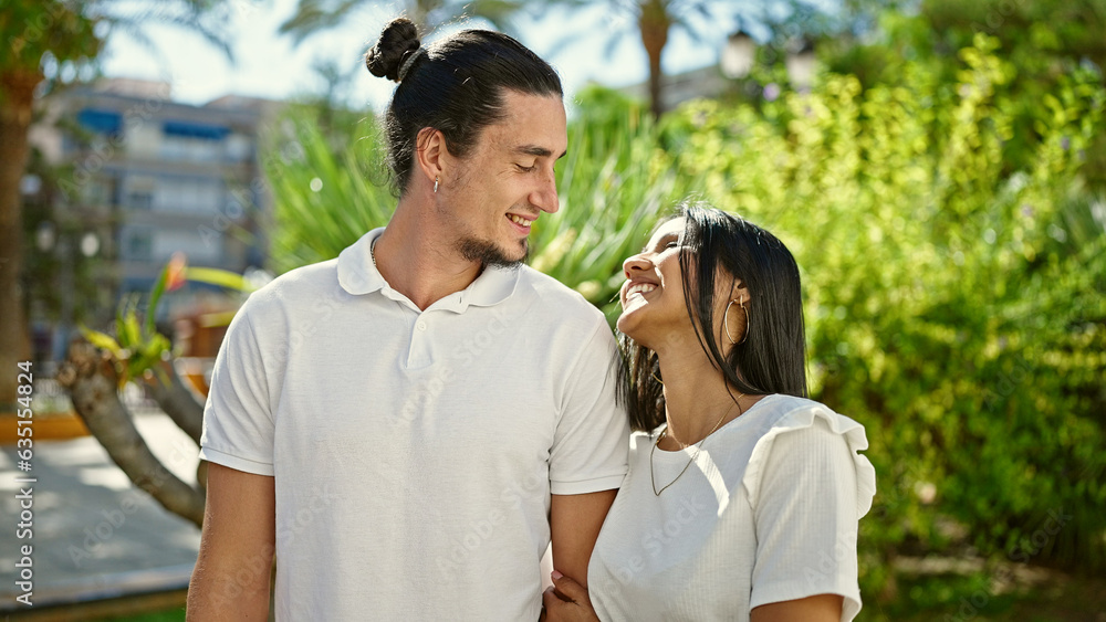 Man and woman couple smiling confident standing together at park Man and woman couple smiling confident standing together at park