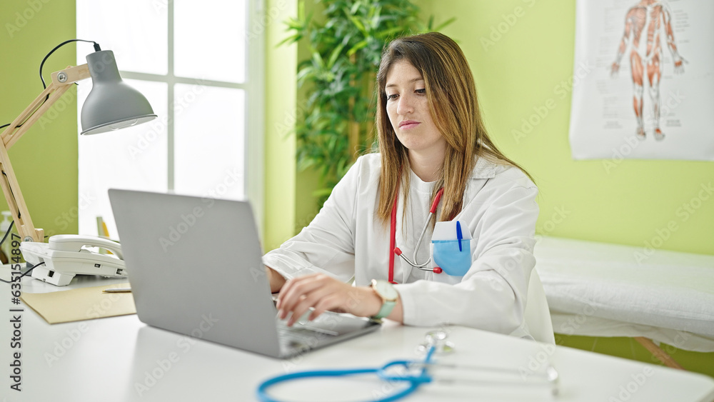 Young blonde woman doctor using laptop working at clinic Young blonde woman doctor using laptop working at clinic