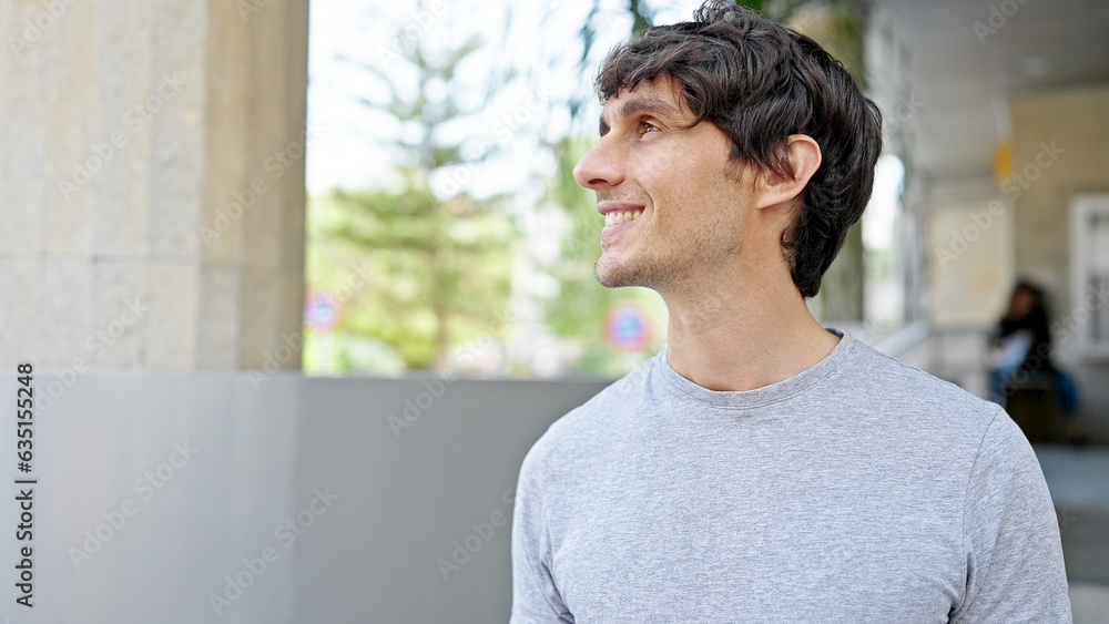Young hispanic man smiling confident looking to the side at street Young hispanic man smiling confident looking to the side at street