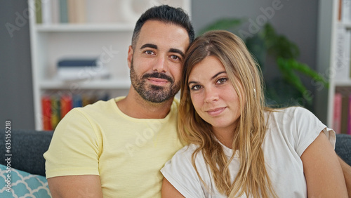 Man and woman couple hugging each other sitting on sofa at home © Krakenimages.com