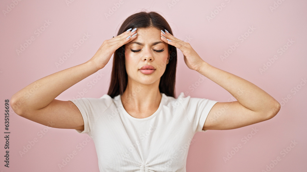 Young caucasian woman suffering for headache over isolated pink background Young caucasian woman suffering for headache over isolated pink background