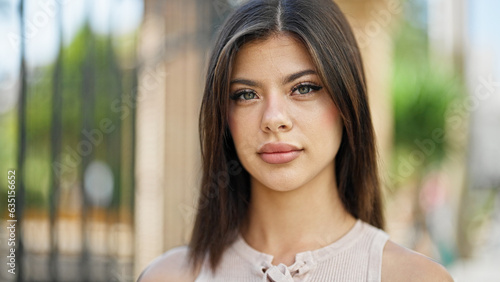 Free Download Young caucasian woman standing with serious expression at street - GFXLoad