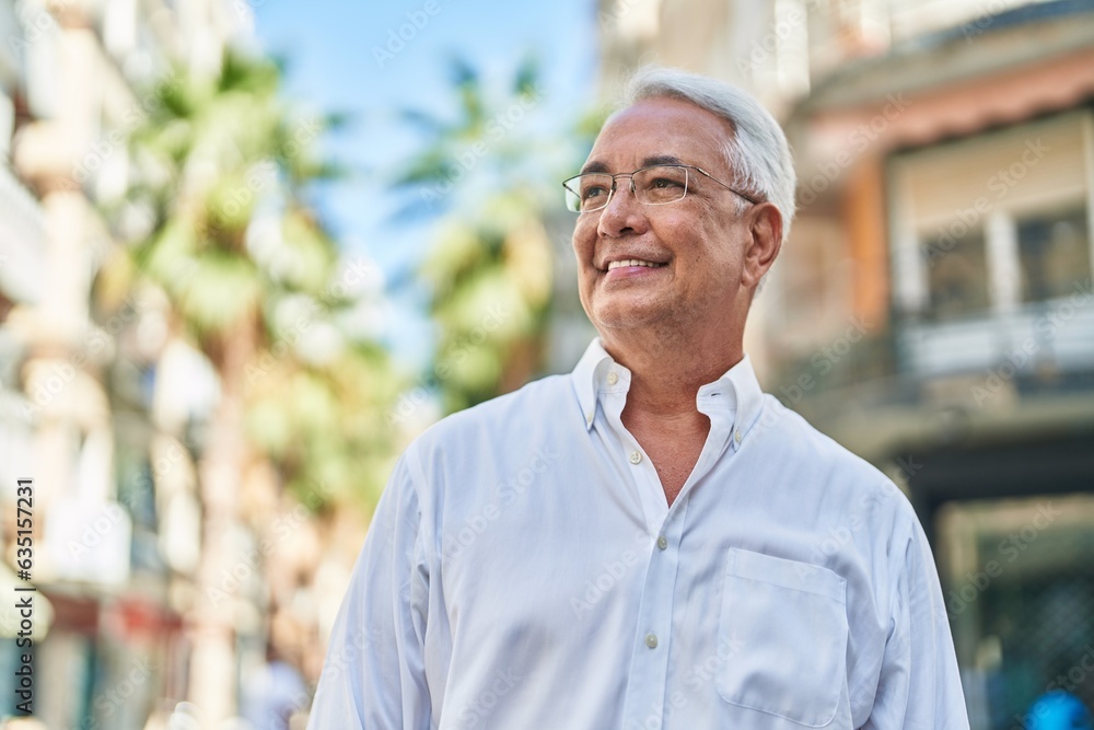 Middle age grey-haired man smiling confident looking to the side at street Middle age grey-haired man smiling confident looking to the side at street