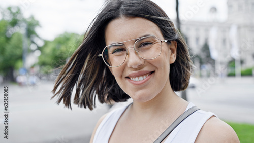 Young beautiful hispanic woman smiling confident standing in the streets of Vienna