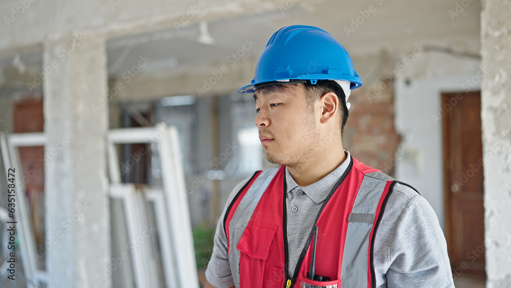 builder standing with serious expression at construction site builder standing with serious expression at construction site