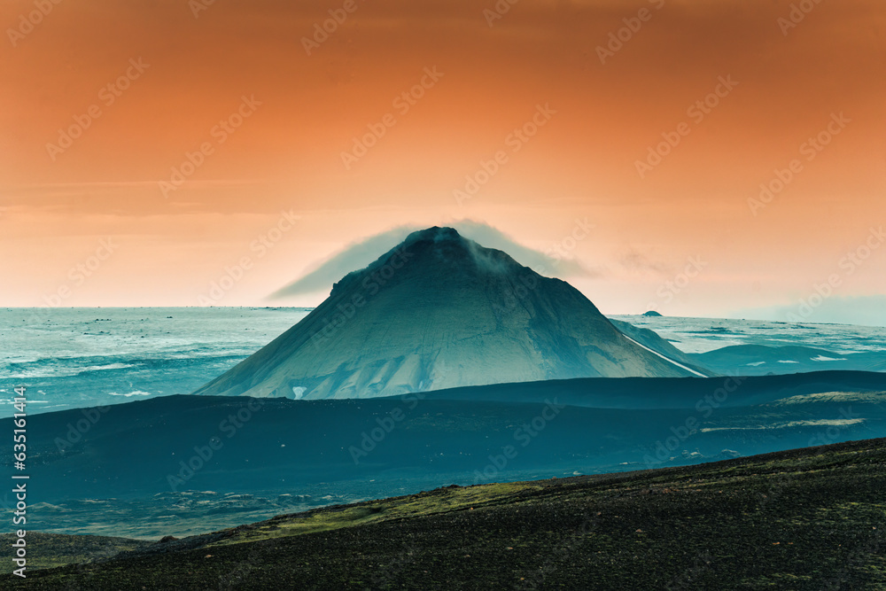 Volcanic mountain with sunset sky among wilderness in summer at Iceland