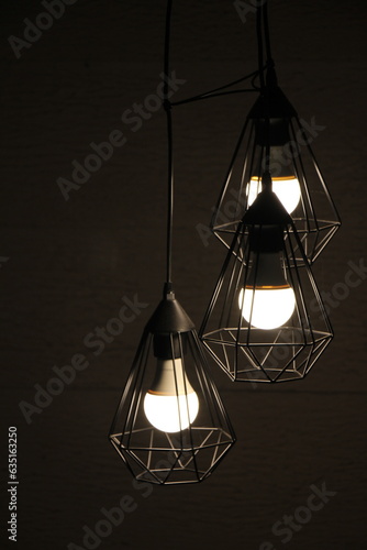 LED Lightbulbs with iron cages against a backdrop of wood panel
