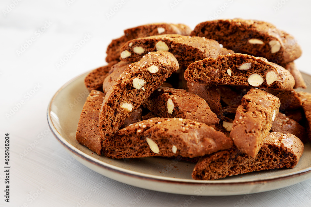 Homemade Italian Cantuccini with Almond and Coffee on a Plate on a gray surface, side view. Crispy Almond and Coffee Cookies. Homemade Italian Cantuccini with Almond and Coffee on a Plate on a gray surface, side view. Crispy Almond and Coffee Cookies.