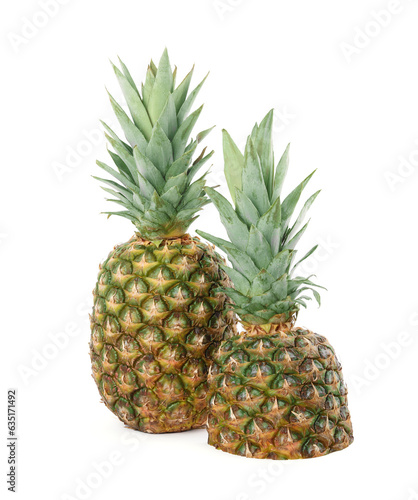 Whole and cut ripe pineapples isolated on white © New Africa