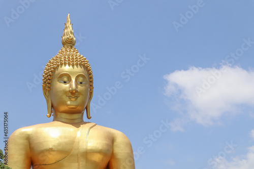 Biggest golden Buddha statue in the world against blue sky and white clouds background Wat Muang  Ang Thong Province  Thailand