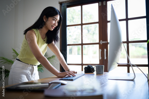 Free Download Happy young Asian Woman working on computer Business Data Analyst. - GFXLoad