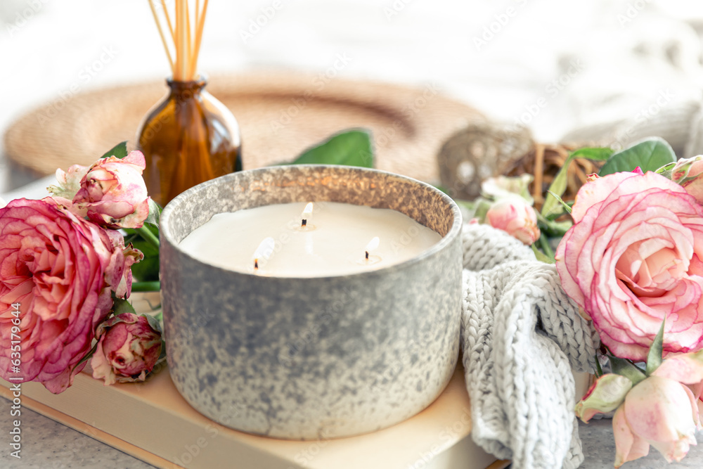 Spa composition with aroma oil diffuser lamp, flowers and candle.