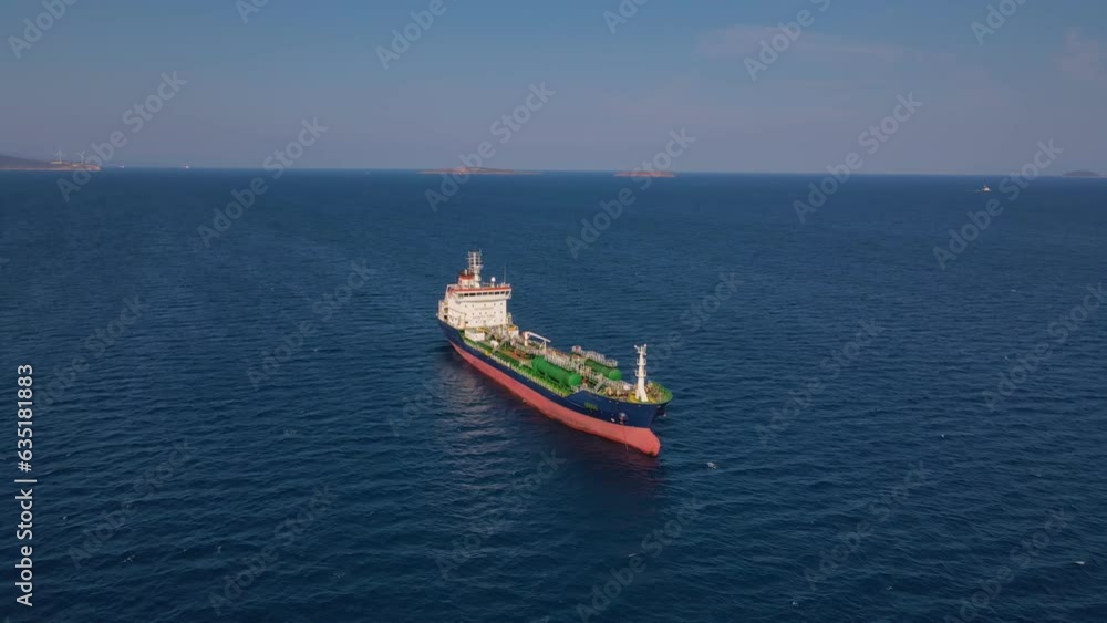 Oil chemical tanker ship holding her position at sea anchorage, aerial wide shot Oil chemical tanker ship holding her position at sea anchorage, aerial wide shot