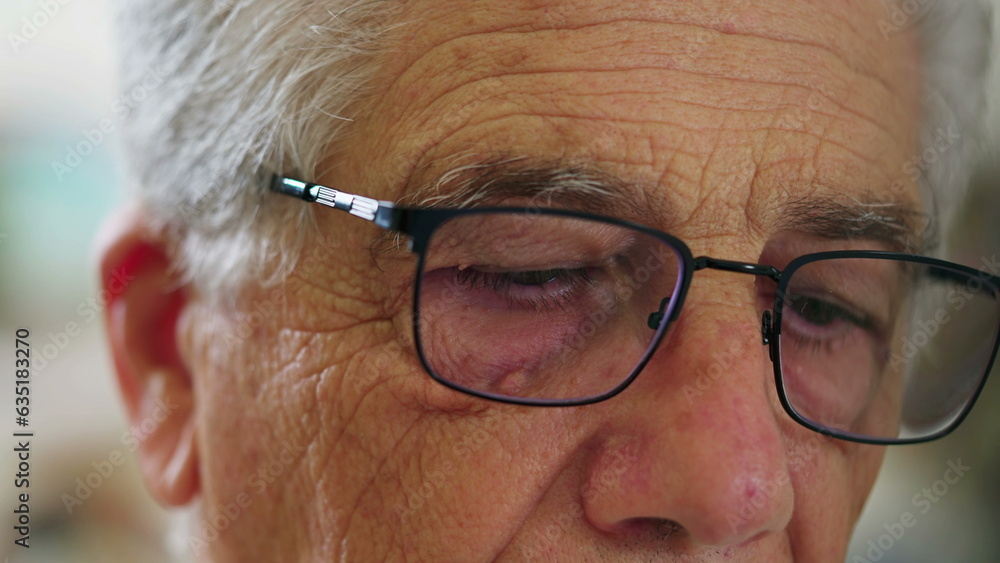 Close-up of senior man wearing glasses in front of laptop computer engaged with modern technology. Detail face of elderly person staring at screen, browsing internet online activity Close-up of senior man wearing glasses in front of laptop computer engaged with modern technology. Detail face of elderly person staring at screen, browsing internet online activity