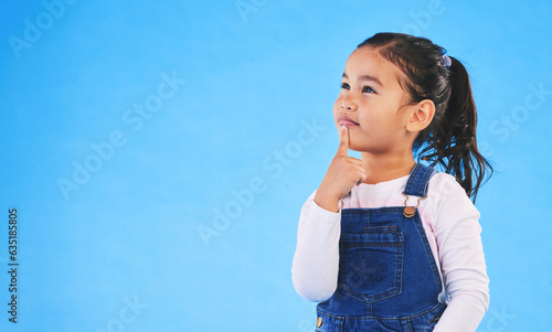 Thinking, child and girl with ideas, solution and question with doubt on a blue studio background. Mockup space, kid or model with planning, choice and inspiration with problem solving or opportunity