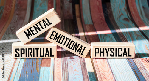 Mental Spiritual Emotional Physical written on wooden blocks and vintage background