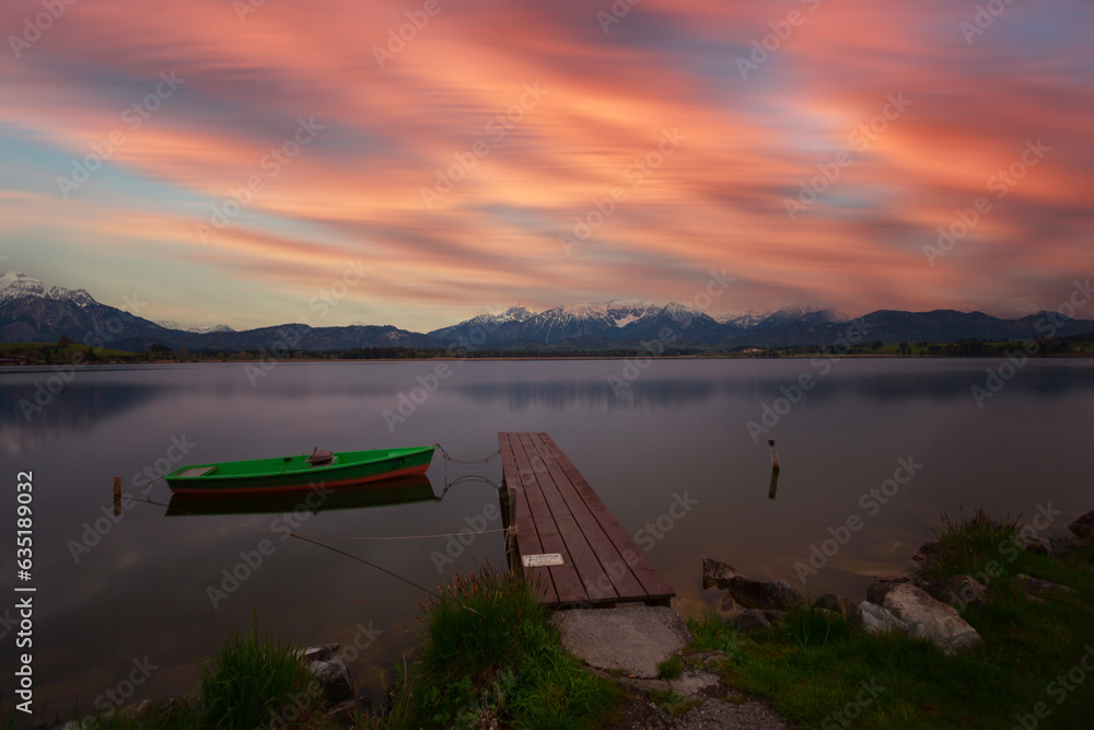 Rowing boat at dock with mountain lake, Allgäu Alps at back, blue hour, Hopfensee, Hopfen am See, Ostallgäu, Bavaria, Germany