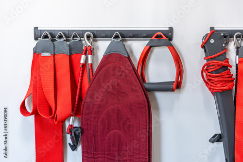 Red cord slings for therapeutic exercises and neuromuscular activation. photo