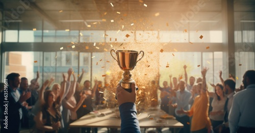 Trophy cup with gold confetti flying around people's hands holding it up.