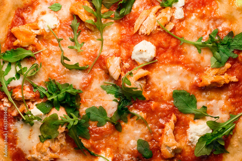 Appetizing wallpaper with Italian pizza with tomato sauce, arugula, mozarella cheese and smoked chicken pieces