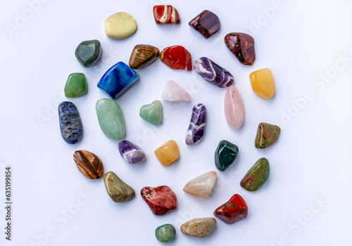 A set of healing minerals (stones) for the chakras. Colorful semi-precious stones in the form of a spiral on a white background. Mineralogy, esotericism, spiritual practices, reiki. Aura Reading.