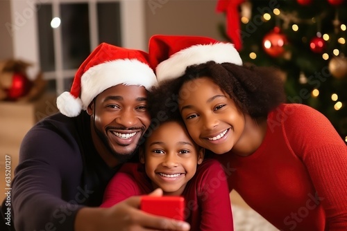 Cheerful African family making selfie together for Christmas