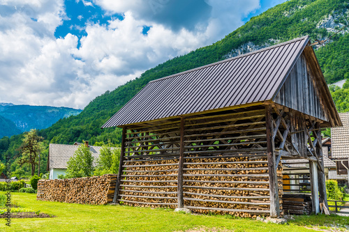 A view along the side of a hay drying frame at the alpine village of Stara Fuzina above lake Bohinj in Slovenia in summertime photo