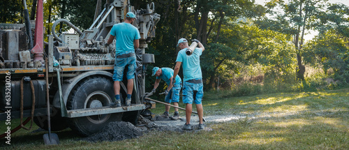 Photos Water well drilling rig preparing to boring dowin into the earth.