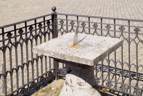An old stone sundial in the old market square in Płock.