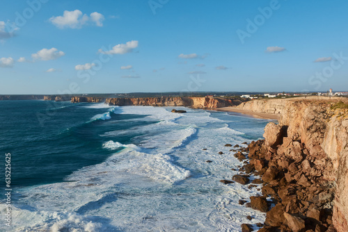 Typical Portuguese landscape - huge cliffs and giant stones washed by the waves of the Atlantic Ocean near Sagres