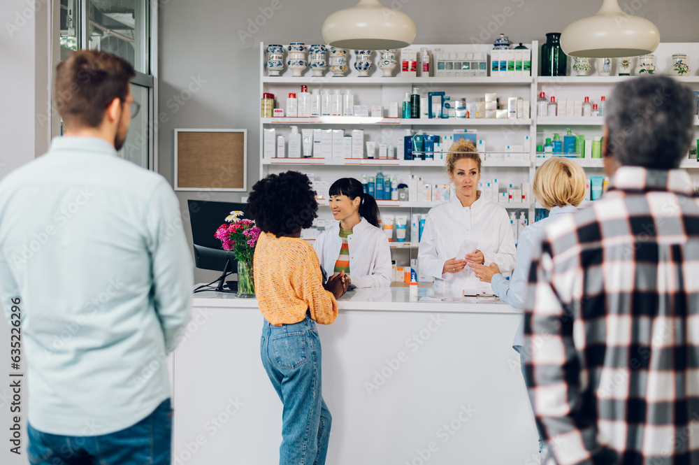 Obraz premium A queue of people standing in a pharmacy while shopping for medicine