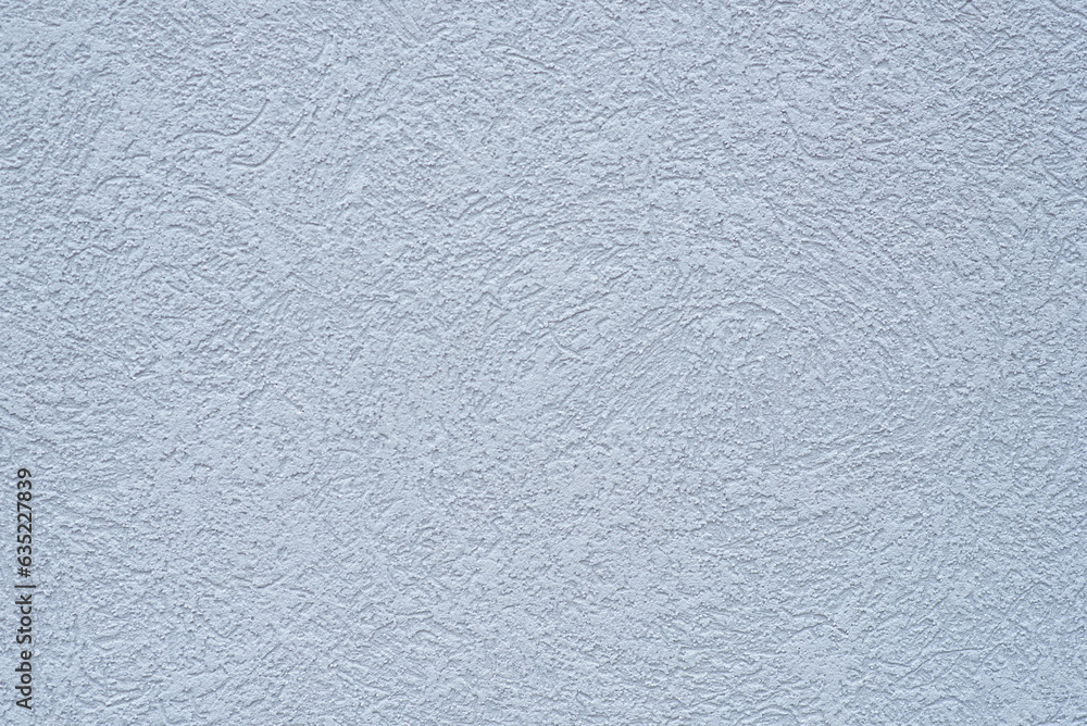 Blue-gray, textured stucco exterior of a building. Backgrounds. Textures. Blue-gray, textured stucco exterior of a building. Backgrounds. Textures.