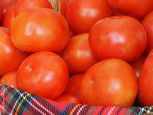 Obraz na płótnie Vegetable still life, fresh tomatoes in a wicker basket, close-up. Natural products, the concept of healthy nutrition. w salonie