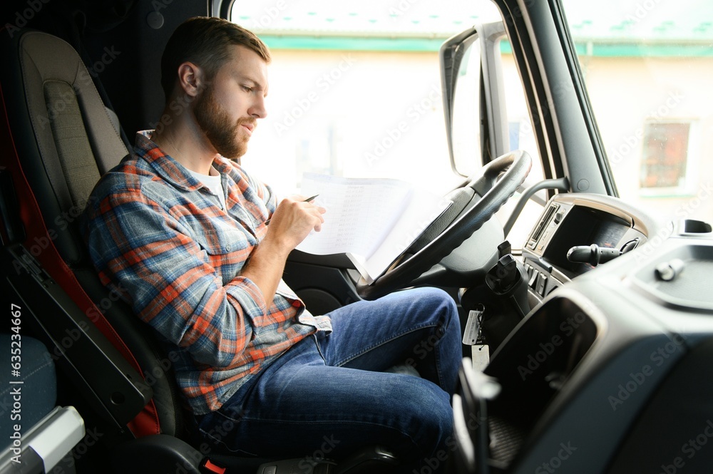 forwarder driver sits behind the wheel of a car and examines waybills documentation for the cargo.